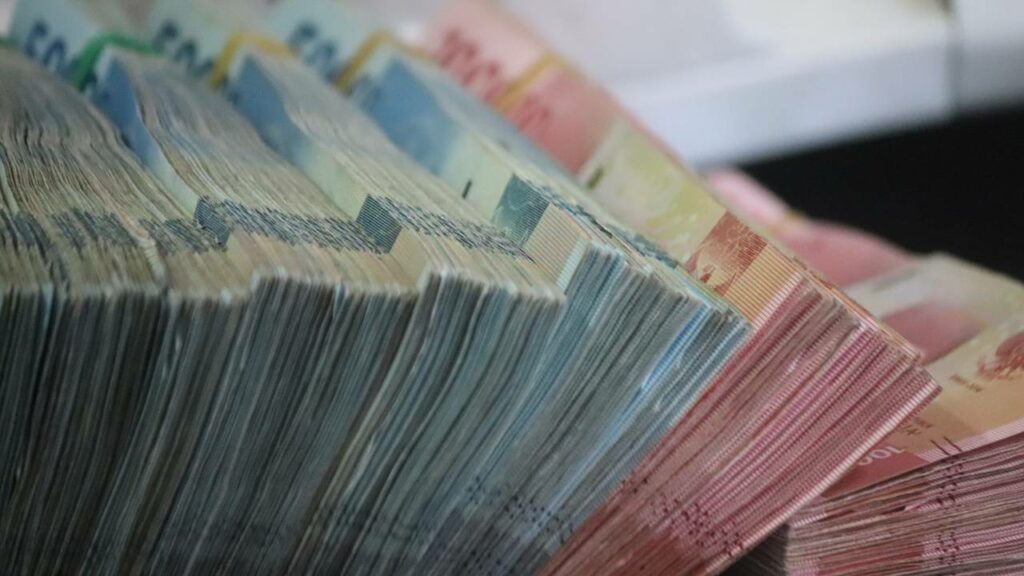 A few stacks of colorful cash bills