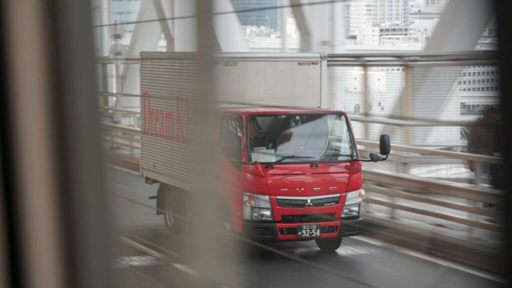 A red truck crossing a bridge